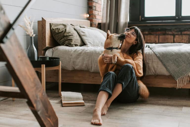 An image of a dog and a woman cuddling, after successful Denver dog training