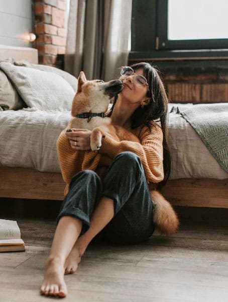 An image of a dog and a woman cuddling, after successful Denver dog training